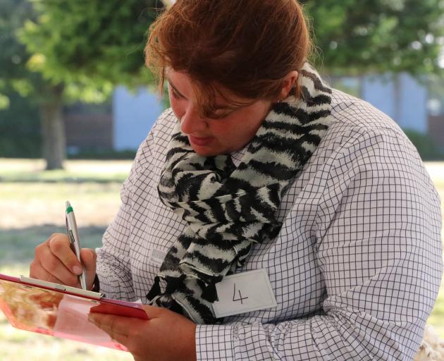 Strath Taieri Young Farmers Club member Elizabeth Graham, of Hindon, considers her scoring during the stock judging competition at the New Zealand Young Farmers Conference in Christchurch earlier this month. She won the national competition. Photo: Suppli