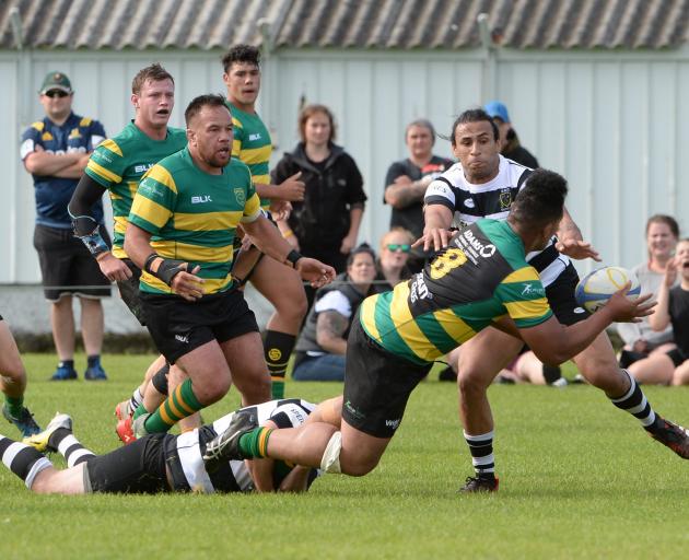 Green Island No8 Lafele Fa'amoe is tackled by Southern fullback Bryce Hosie (on ground) as Josh...