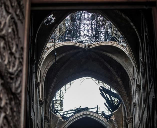 A view of the damaged roof inside Notre-Dame de Paris in the aftermath of a fire that devastated...