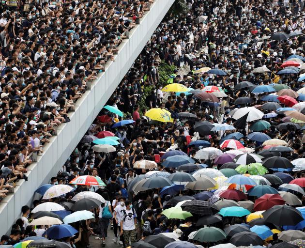 Protesters march along a road demonstrating against a proposed extradition bill in Hong Kong....