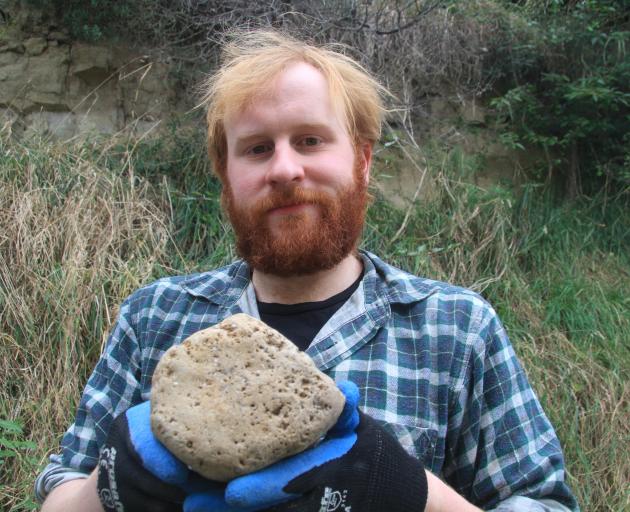 Assistant research fellow Marcus Richards shows the telltale "honeycomb'' in a fossilised whale...