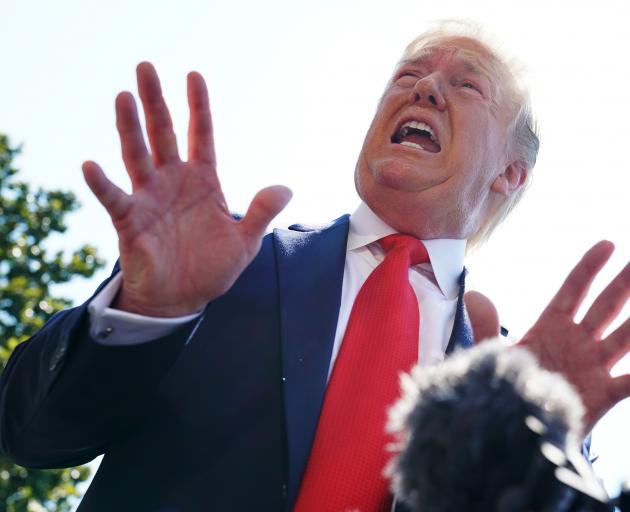 US President Donald Trump speaks to members of the media Friday prior to departing for his golf...