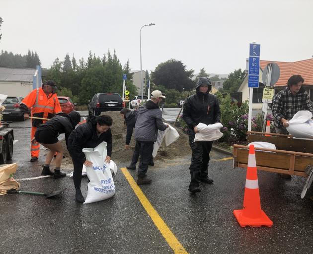 Volunteers from Kai Whakapai arrived at 9am to get free sand bags from Dunmore St car park. Photo: Kerrie Waterworth