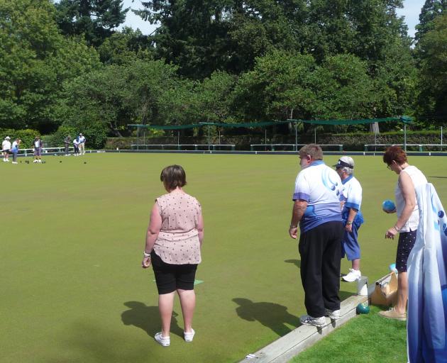 A couple of bowling newcomers give the game a go at the club's open day on Saturday. Photo: Ashburton Courier