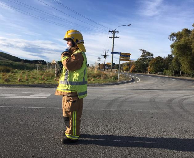 A firefighter near the scene of a collision between a train and a truck. Photo: Christine O'Connor