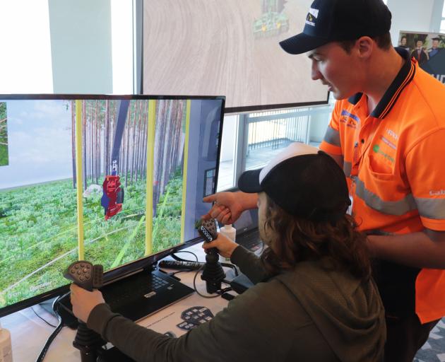 Hands on ... Josh Hurring, of Mike Hurring Logging and Contracting, helps Emiliano Heguaburu on a...