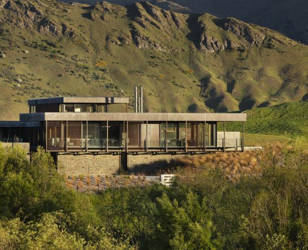 Corten steel, shuttered concrete and schist give this Speargrass Flat home a rustic look and help...