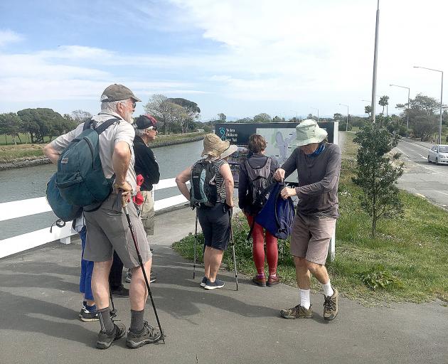 Walkers stop at the start of Te Ara Otakaro Avon Trail, which former red zone resident Evan Smith...