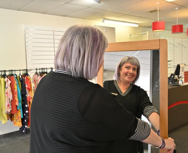 H&J Smith Mosgiel senior retail assistant Ellen Smart moves a full-length mirror in preparation...