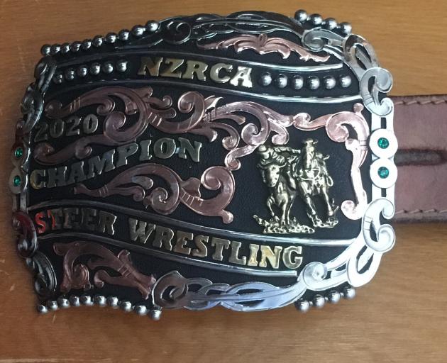 A buckle and saddle (below) were awarded to Greg Lamb for winning the 2020 national steer...