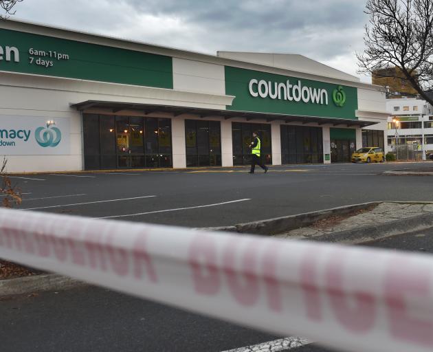 A security guard patrols the empty Countdown carpark this morning. PHOTO: PETER MCINTOSH