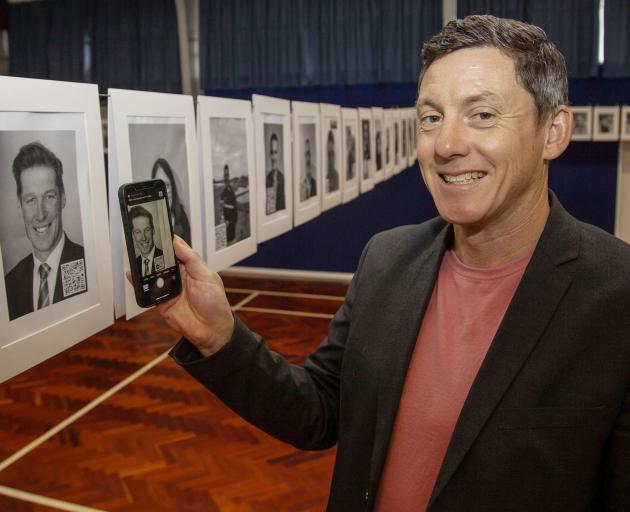 Nick Leith, deputy principal at Casebrook Intermediate School, scans the QR code on the photo of...