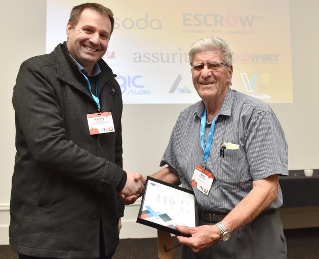 IT Professionals New Zealand national president Anthony Dowling presents Bruce McMillan with an...