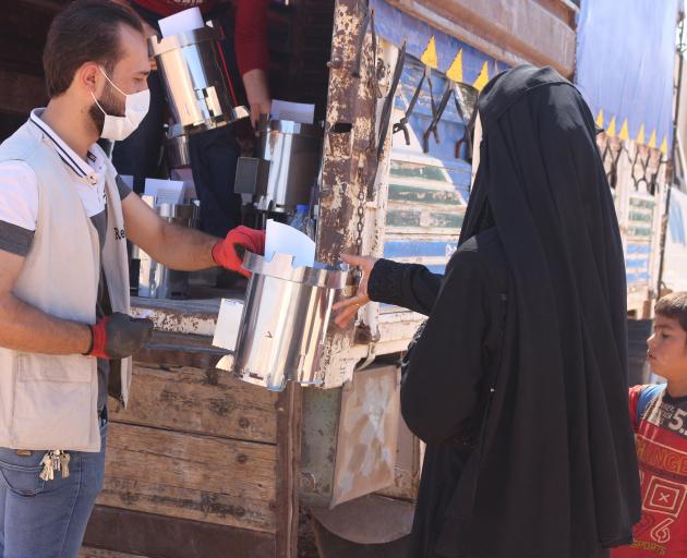 A Syrian family receive an assembled Fire for Life stove from the ReliefAid team in Syria. PHOTO:...