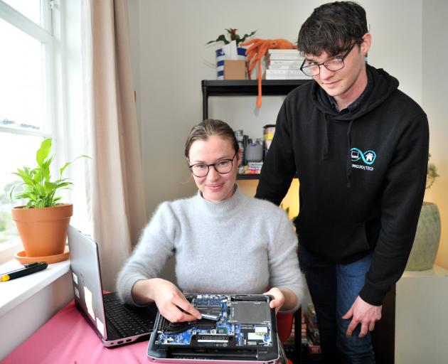 Displaying a used laptop that is being refurbished for school pupils are Recycle a Device donor...