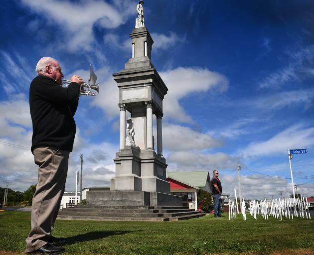 Warrick Thompson plays Last Post at the Balclutha War Memorial to an audience of RSA members,...
