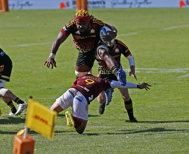 Pita Gus Sowakula hurdles Aaron Smith's attempted tackle on his way to the try line. Photo: Getty...
