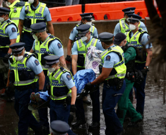 A person has been carried away from the protest on a stretcher. Photo: NZ Herald