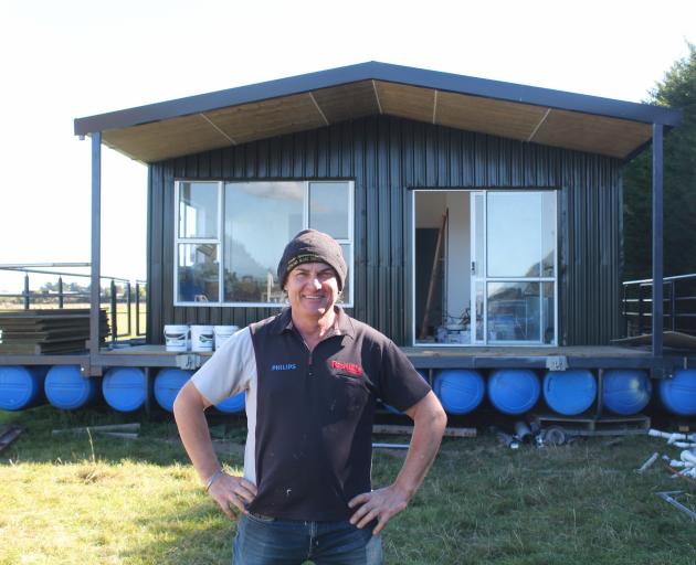 Ian Horsham in front of his houseboat. PHOTO: VALU MAKA