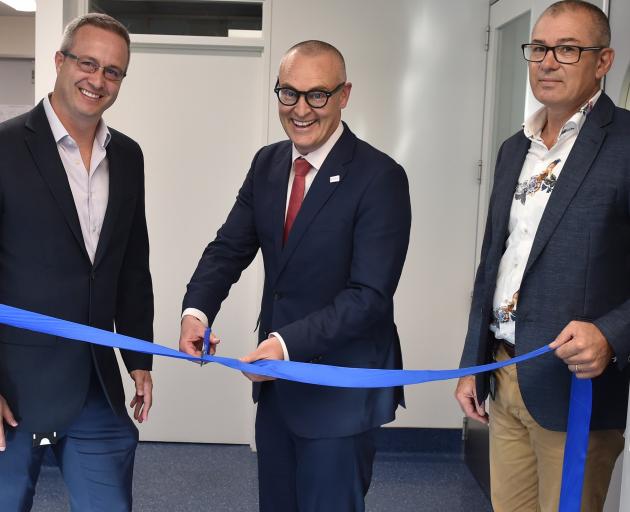 Pacific Edge executives Dr Peter Meintjes (left) and Brent Pownall (right) cut the ribbon to the...