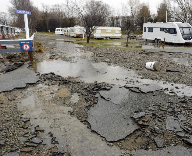 Asphalt was lifted by the flooding at the Omarama Top 10 Holiday Park. The caravan (right) was...