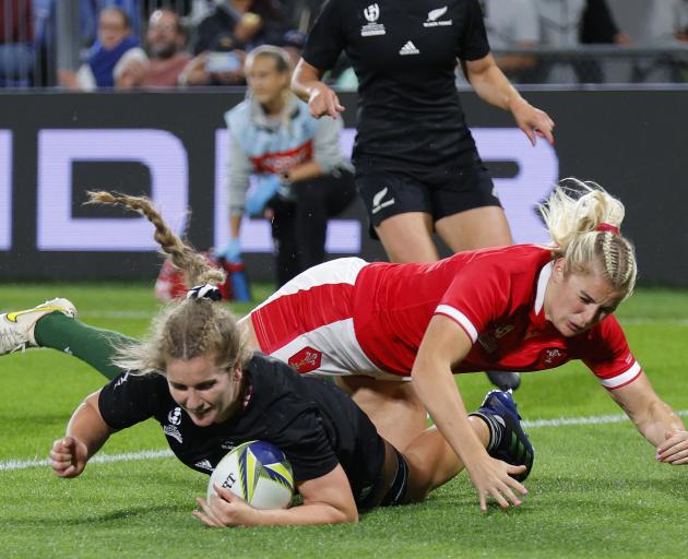 Alana Bremner of New Zealand scores a try during tonight's quarter-final match against Wales in...