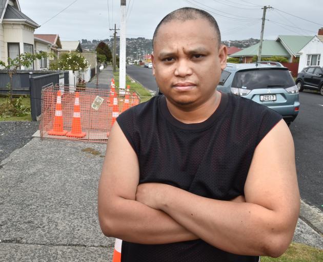 Dunedin resident Deo Cabale outside his Bellona St home, where a sinkhole caused the footpath to...