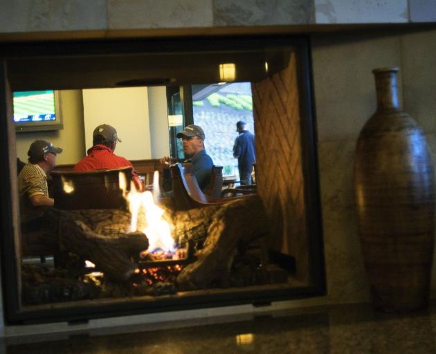 Golfers relax in the bar area at Westin Bear Mountain Resort & Spa, Vancouver Island.