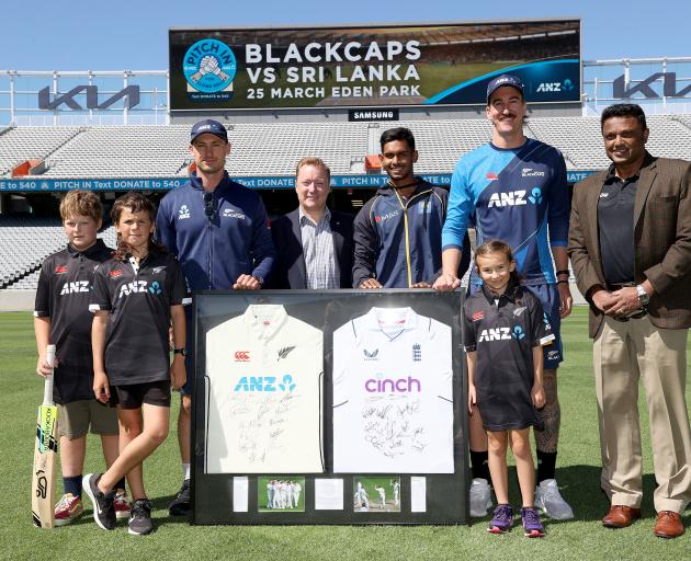 Blair Tickner and Will Young of the Black Caps and Sri Lanka captain Dasun Shanaka pose with...