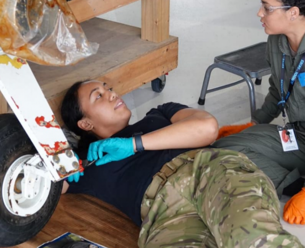 Joanna Maoate instructs a student learning how to attach a wheel to an aircraft. Photo: RNZ