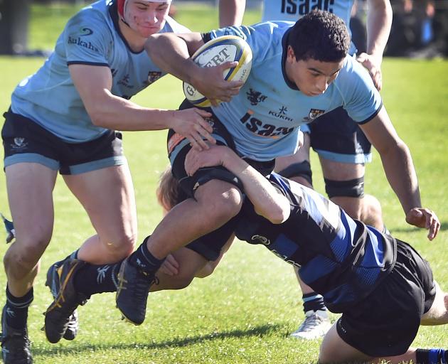 King’s High School forward Kalani Vanisi has team-mate Tom Lewis in support as he tries to evade...