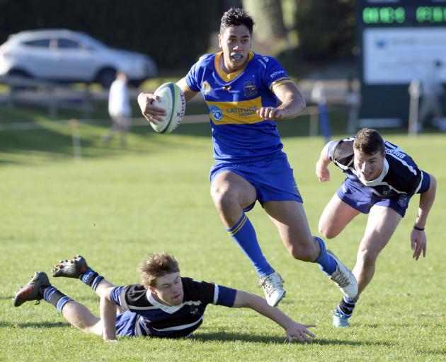 Taieri centre Josh Whaanga heads for the tryline as he leaves Kaikorai defenders Oliver Foote ...