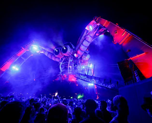 People enjoy their time near the Arcadia stage at the Glastonbury Festival site in Somerset,...