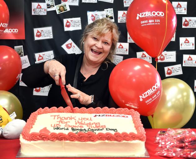 Anne Jaquiery-Newall cuts the cake to mark World Blood Donor Day at the Dunedin Donor Centre...