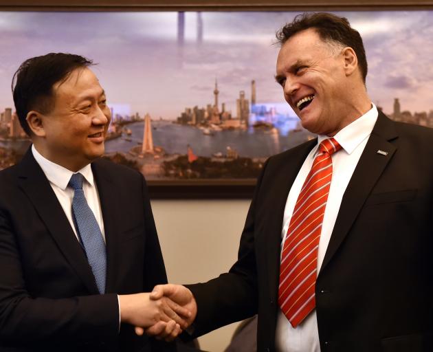 Shanghai vice-mayor Hua Yuan and Dunedin Mayor Jules Radich shake hands in front of a photo of...