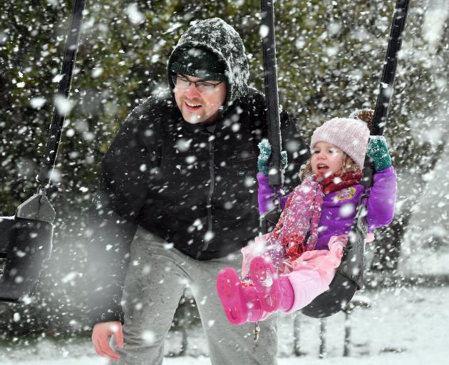 Cameron Fulton and his daughter Hazel (2) enjoy a swing in the Brockville playground as the snow...