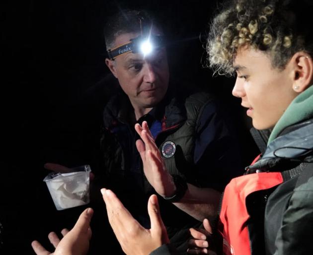 Project Island Song general manager Richard Robbins shows Te Manawa Chapman, 14, an R Tucker...