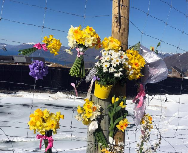 Floral tributes paid to Anita Graf during a blessing at Coronet Peak. Photo: Sheena Haywood