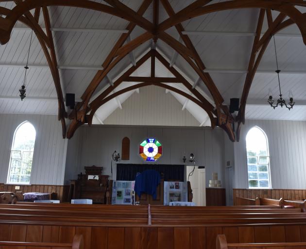 The interior of Pukehiki Church, which has had paint stripped from beams, walls repainted, and...