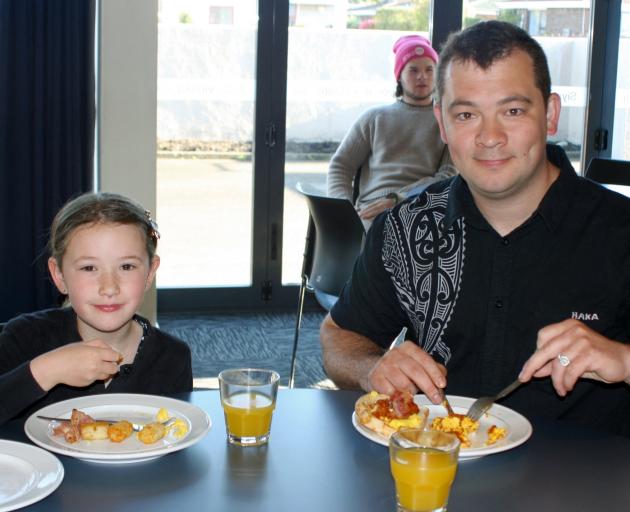 Frikkie Du Plessis enjoys a cooked breakfast with his daughter Lourencia, 6, at the Invercargill...