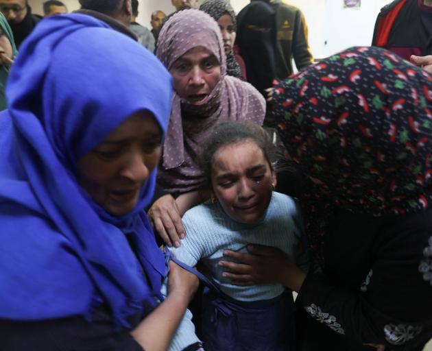 People rush to Nasser hospital in Khan Younis in southern Gaza Strip following an Israeli strike...