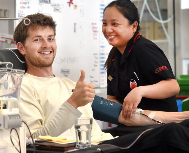 Andrew Searle, 25, gives blood with a helping hand from nurse Issa Galagala at NZ Blood Dunedin...