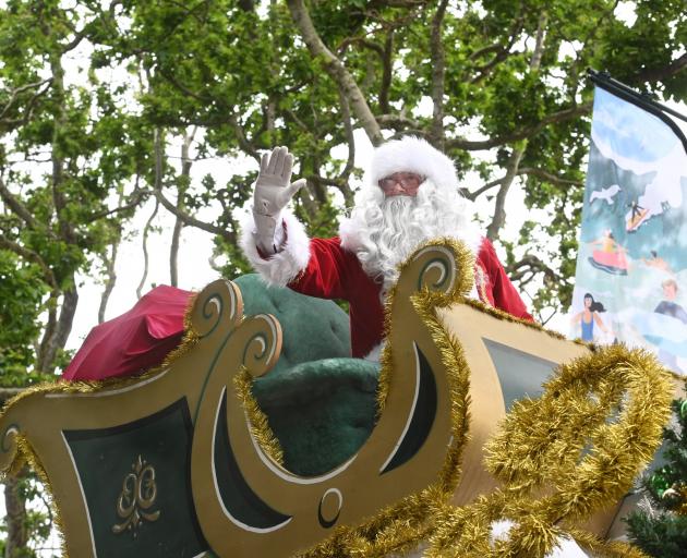 Santa waves to the crowd from his sleigh at the 2023 Dunedin Santa Parade yesterday. PHOTOS:...