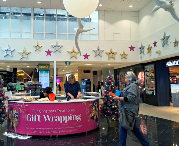 Golden Centre manager Nina Rivett assists with the mall's gift-wrapping service, as Christmas...