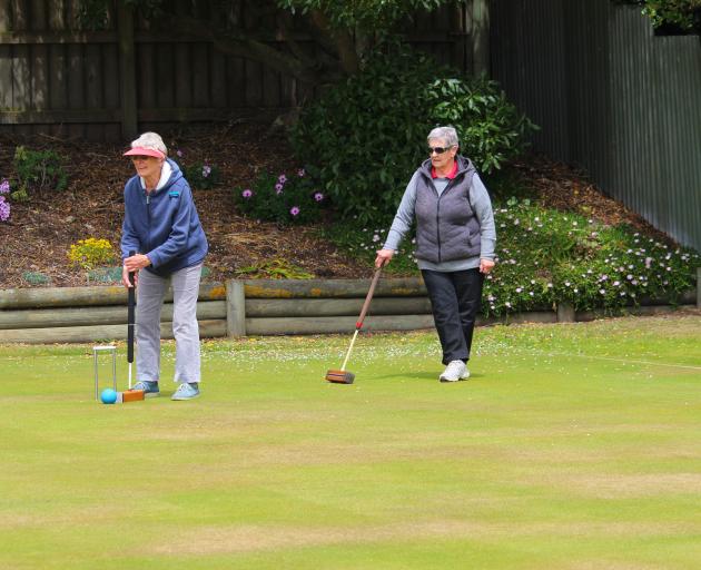 Trying out new variant of croquet are Lynn Howson (left) and June Frood.