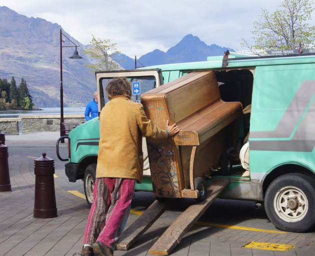 AJ Hickling loading his piano into his van. 