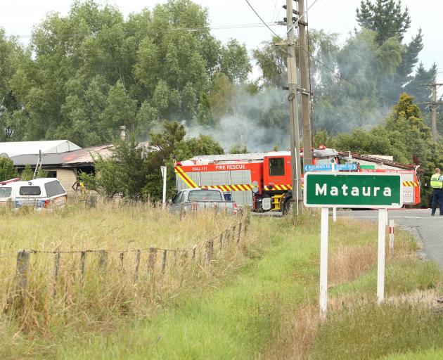 Fire crews work at the scene of a house fire in Mataura yesterday morning. PHOTO: BEN ANDREWS