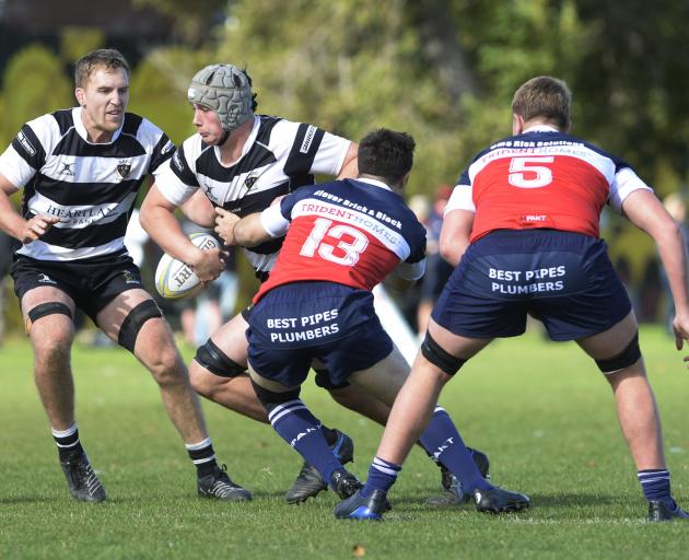 Southern lock Archie Treadwell tries to bust through the tackle of Harbour centre Reuben Wairau....