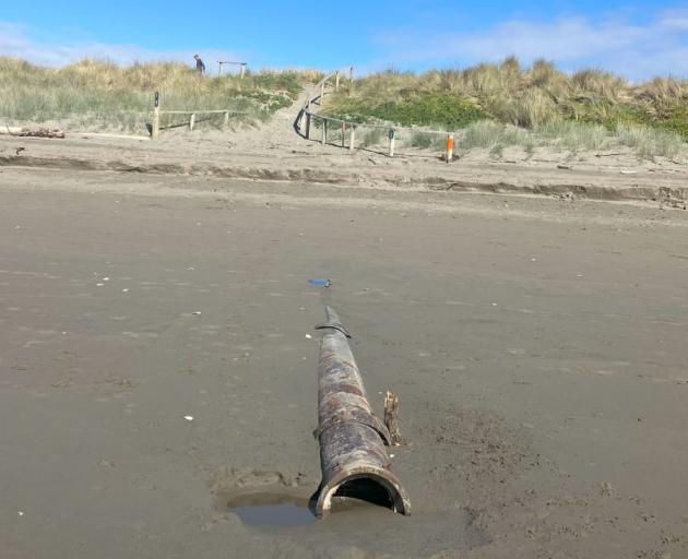 An outfall pipe at New Brighton beach submerged in sand. Photo: Supplied / Kim Money