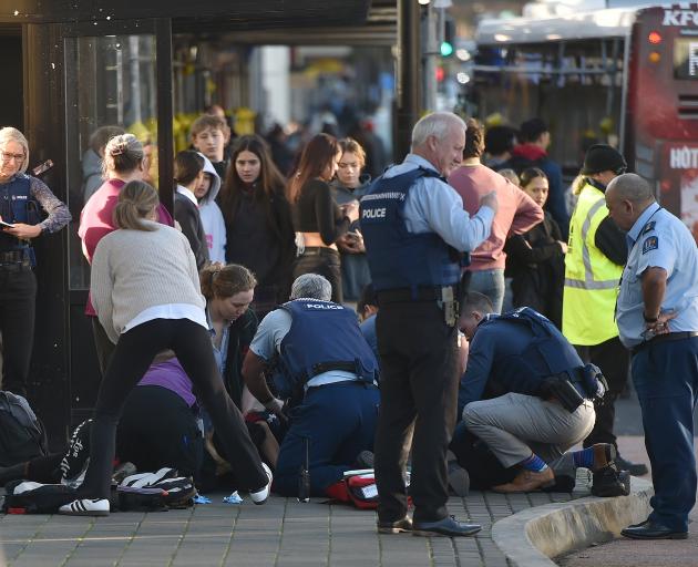 Emergency services attend to the teenager at the Dunedin bus hub yesterday. PHOTO: GREGOR RICHARDSON